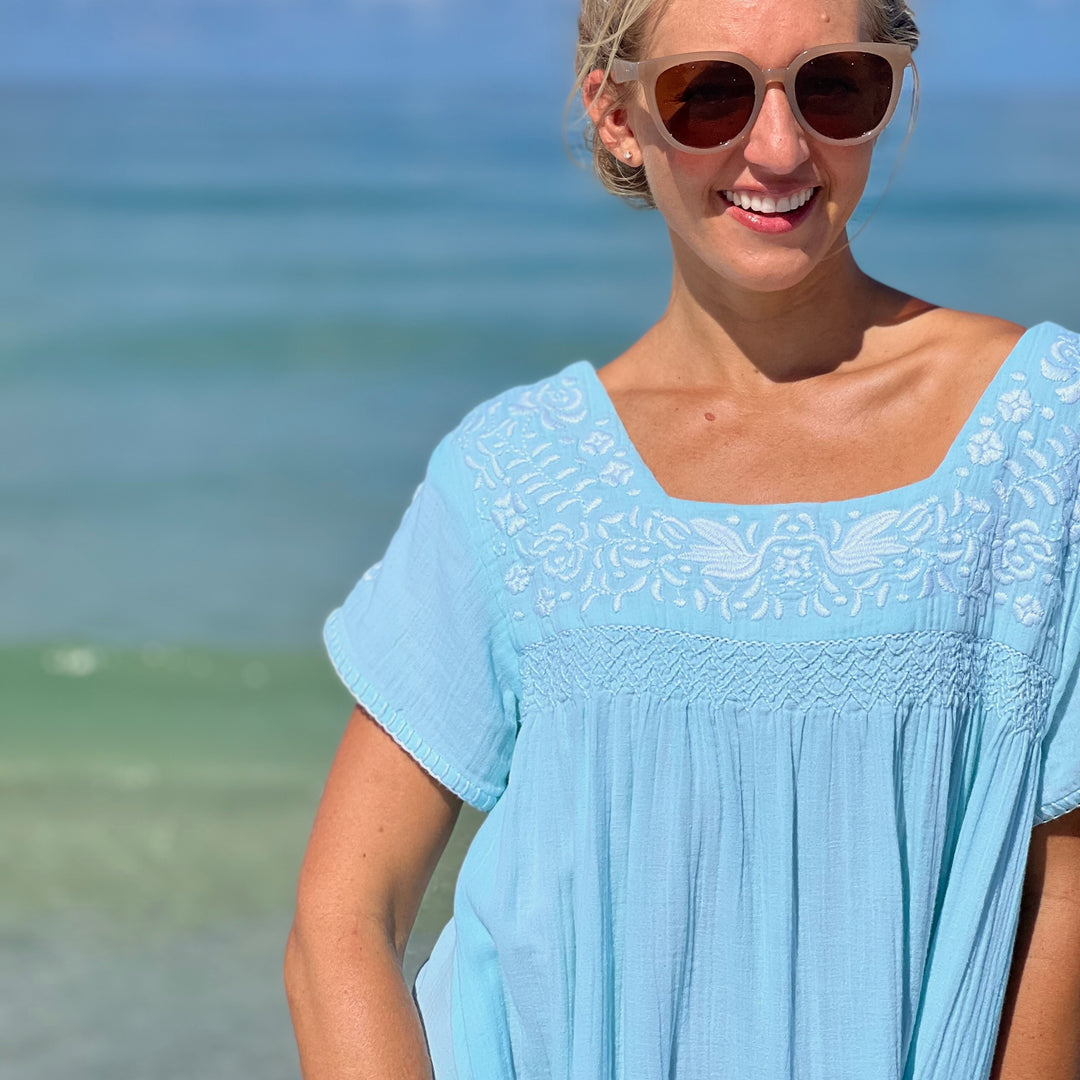 woman in light blue tunic
