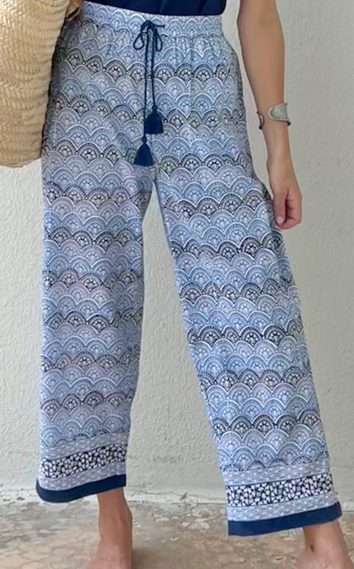 woman standing in blue printed pants