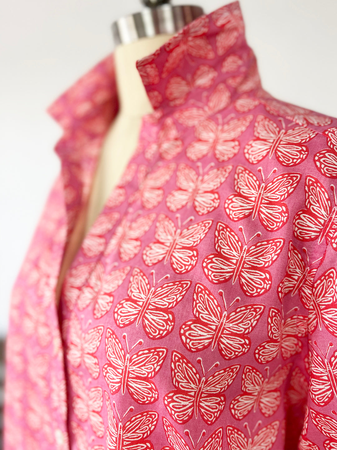 close up of artisan shirt with butterfly print