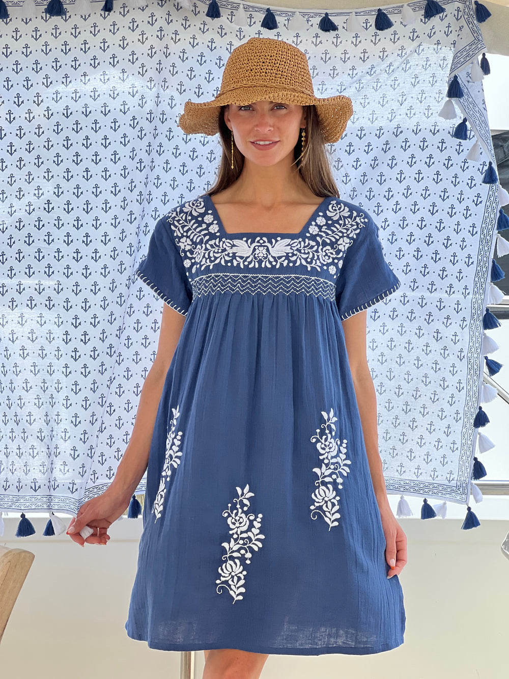 woman standing in front of cotton tassel shawl in navy tunic by sigrid olsen