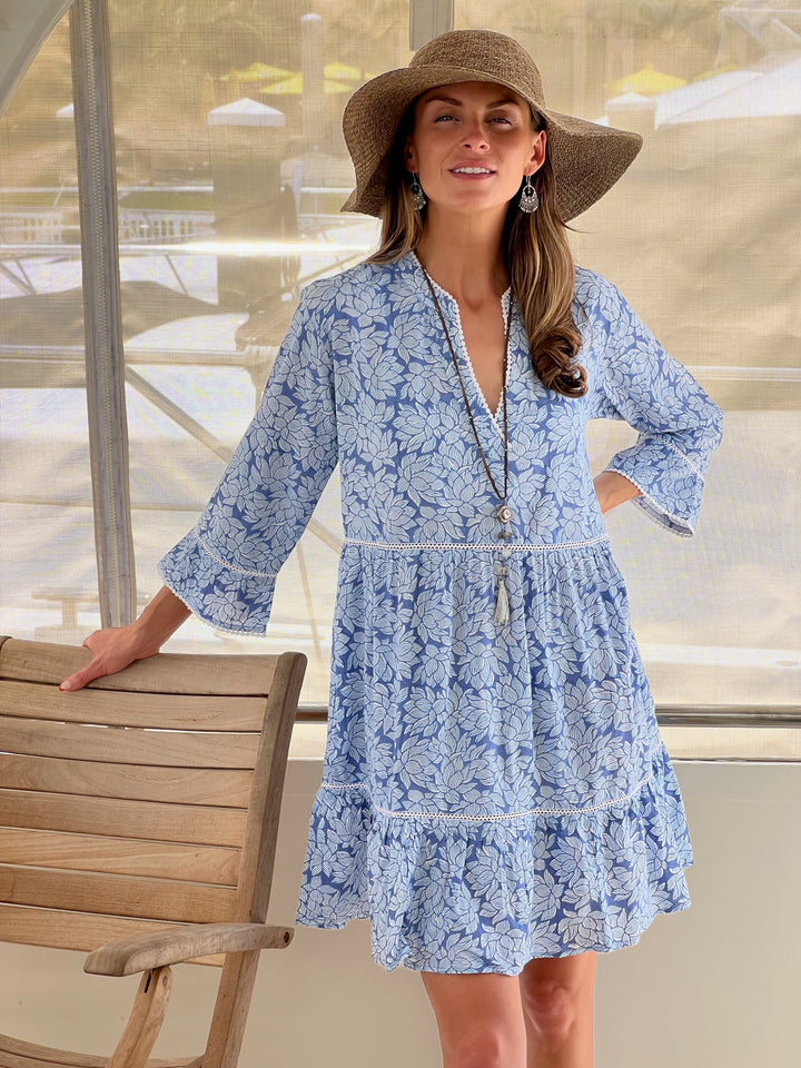 Woman in blue Morrea dress with floral print.jpg