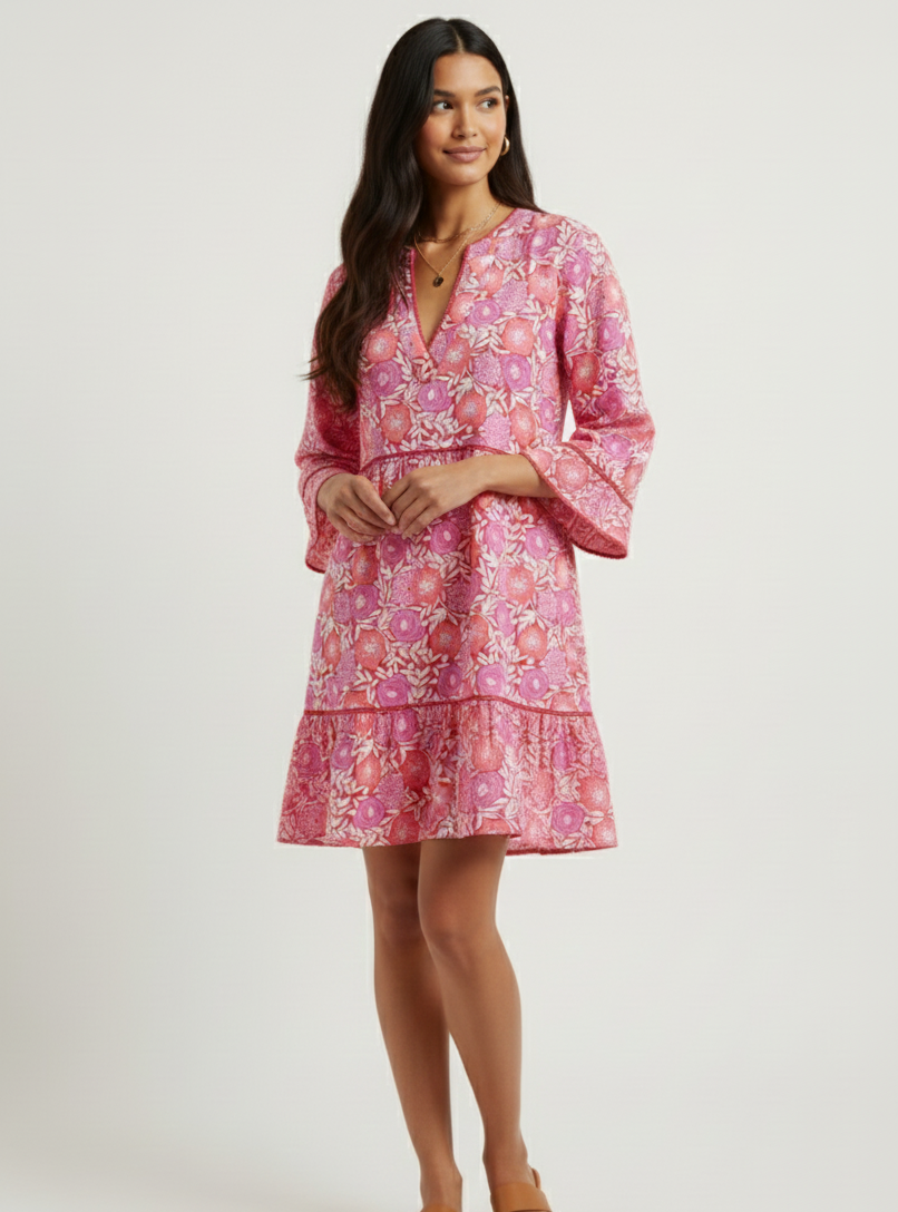 Woman wearing a pink floral dress on a white background