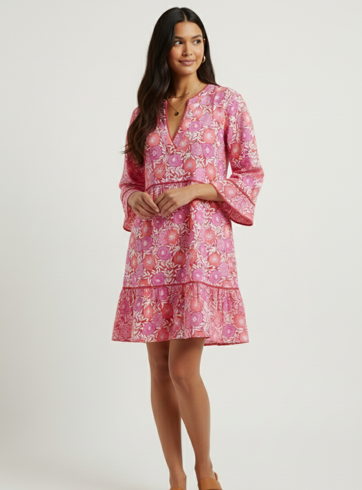 Woman wearing a pink floral dress on a white background