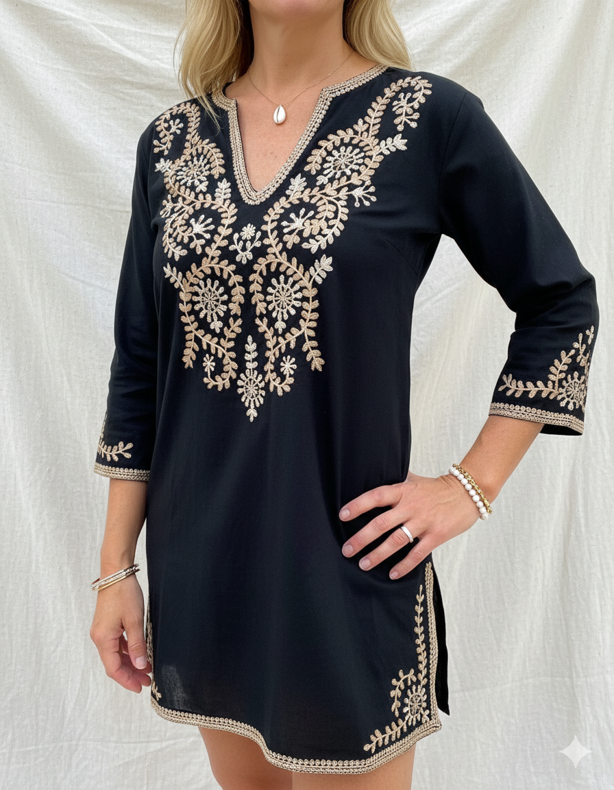 Black dress with gold embroidery on a white background