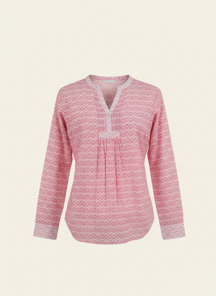 Pink patterned blouse on a light beige background