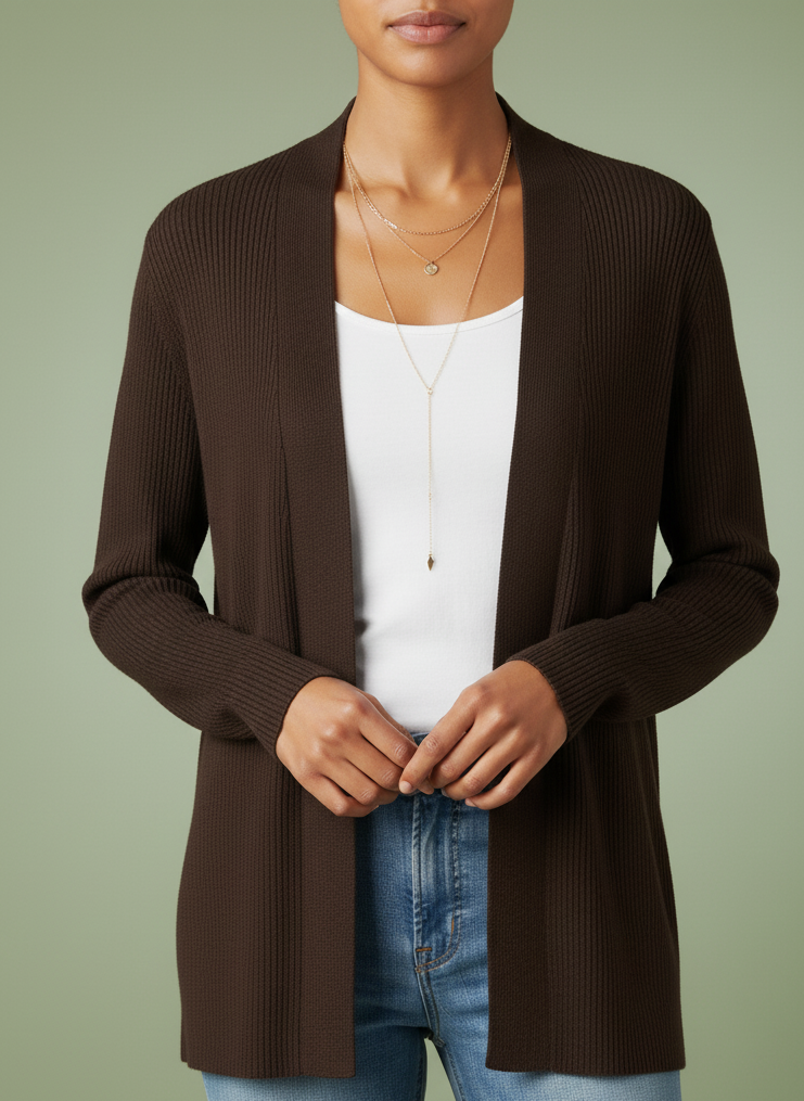 Person wearing a vintage sigrid olsen brown cardigan over a white top and blue jeans on a green background