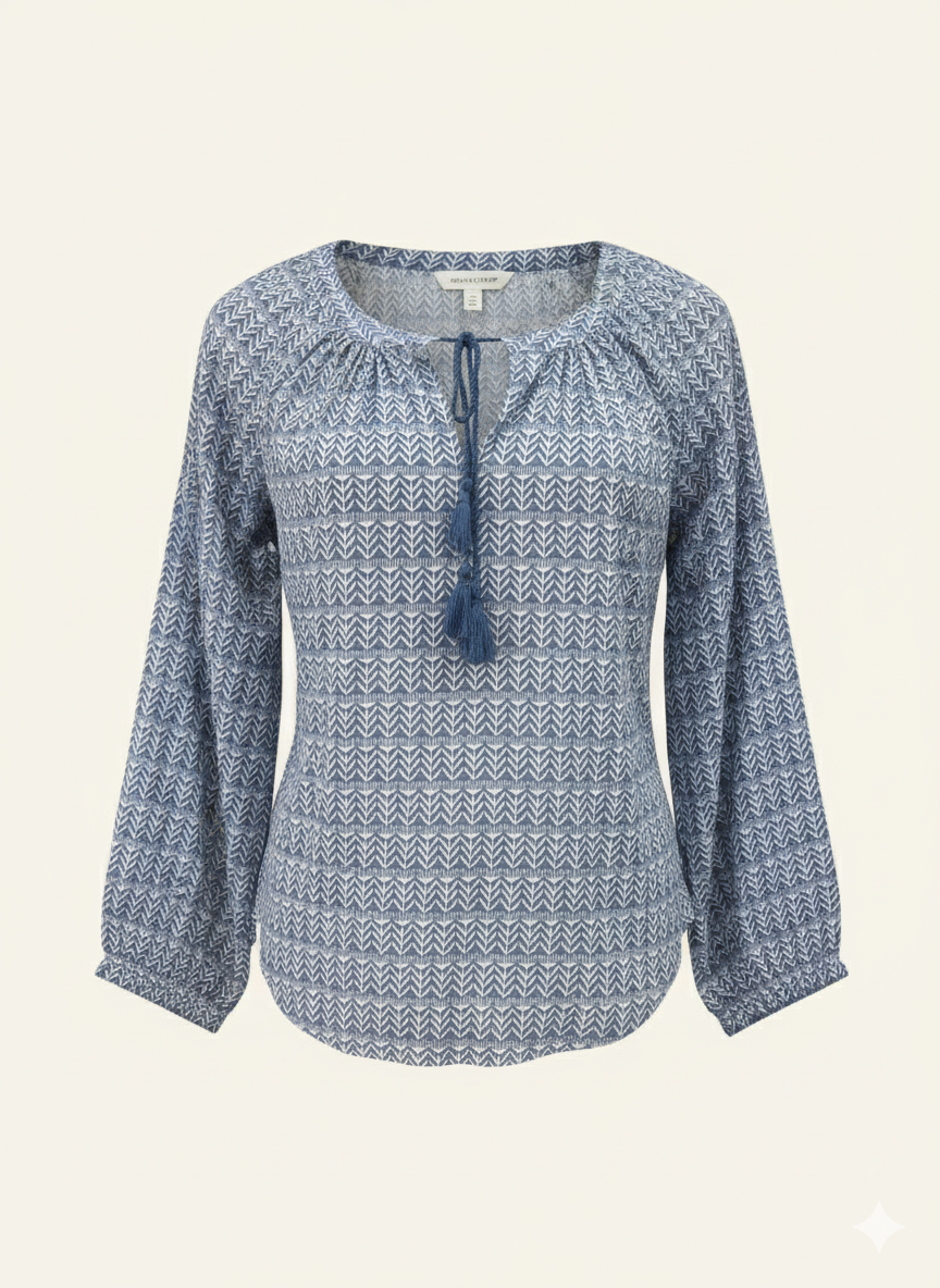 Blue patterned blouse with long sleeves on a beige background