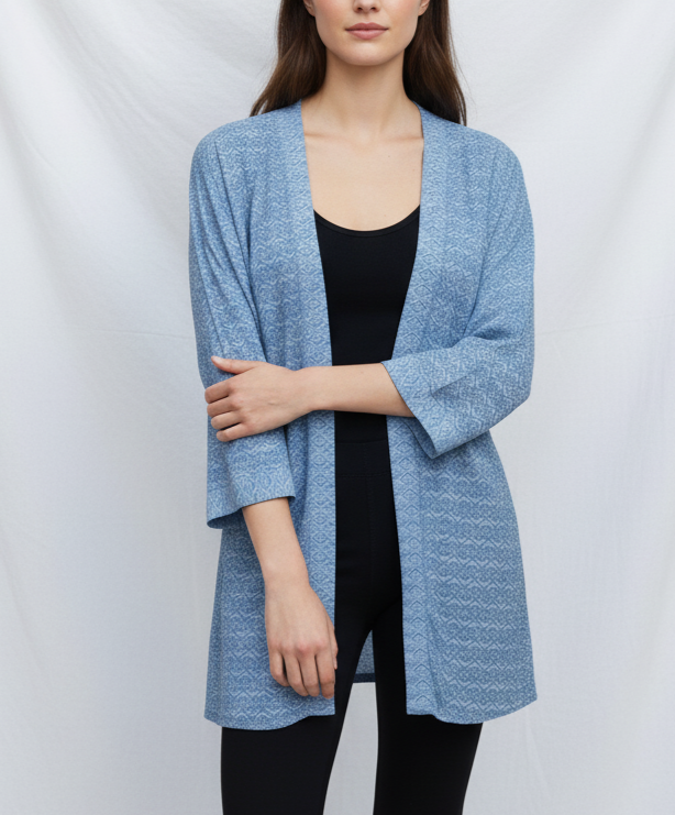 Woman wearing a blue kimono over a black top on a white background