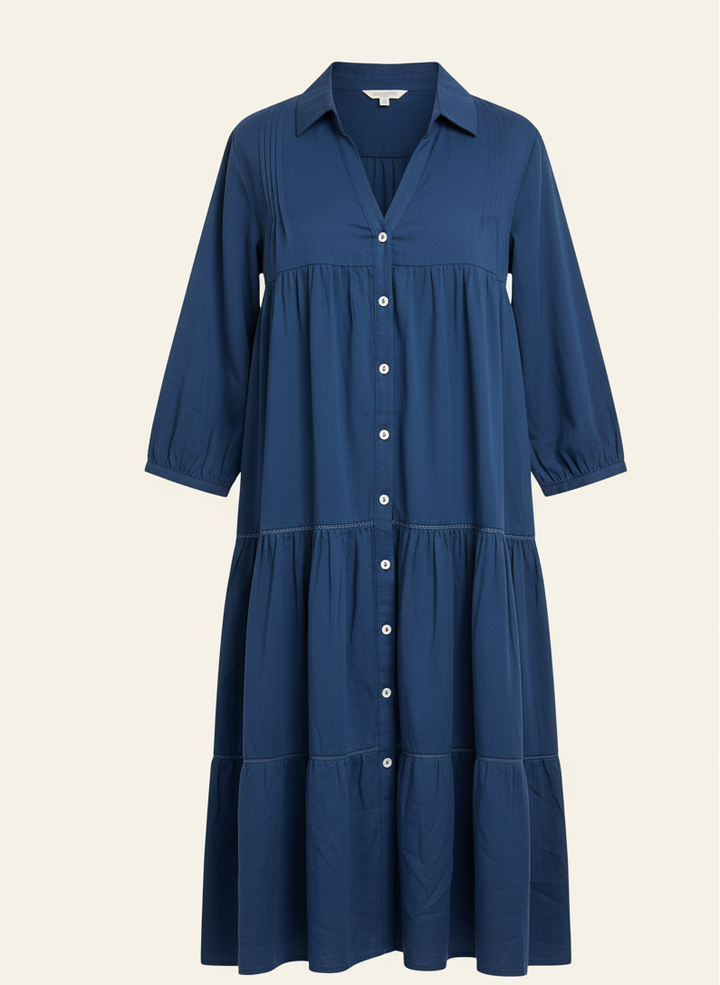 Blue dress with button details on a beige background
