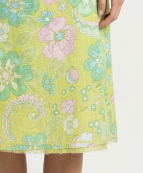 Close-up of a vintage sigrid olsen floral skirt with green, pink, and white colors on a white background