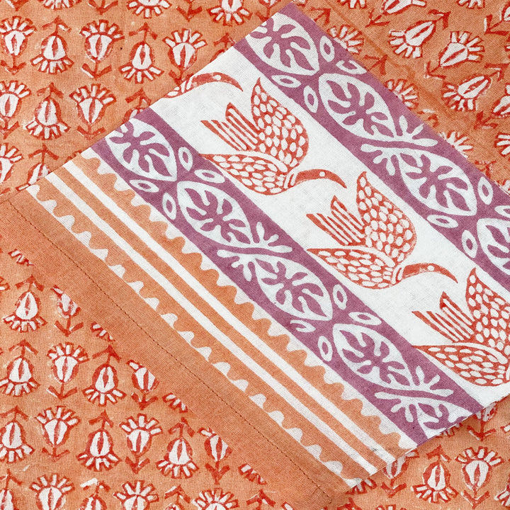 close up of tunic with original hand carved print by sigrid olsen in orange