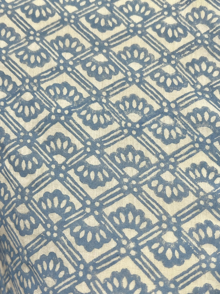Patterned fabric with blue geometric design on beige background