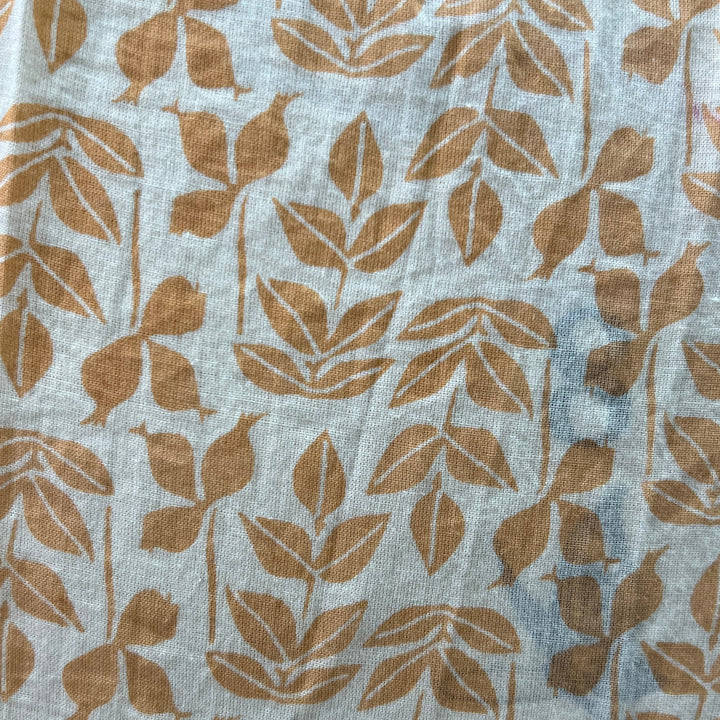 Fabric with brown leaf pattern on a light blue background