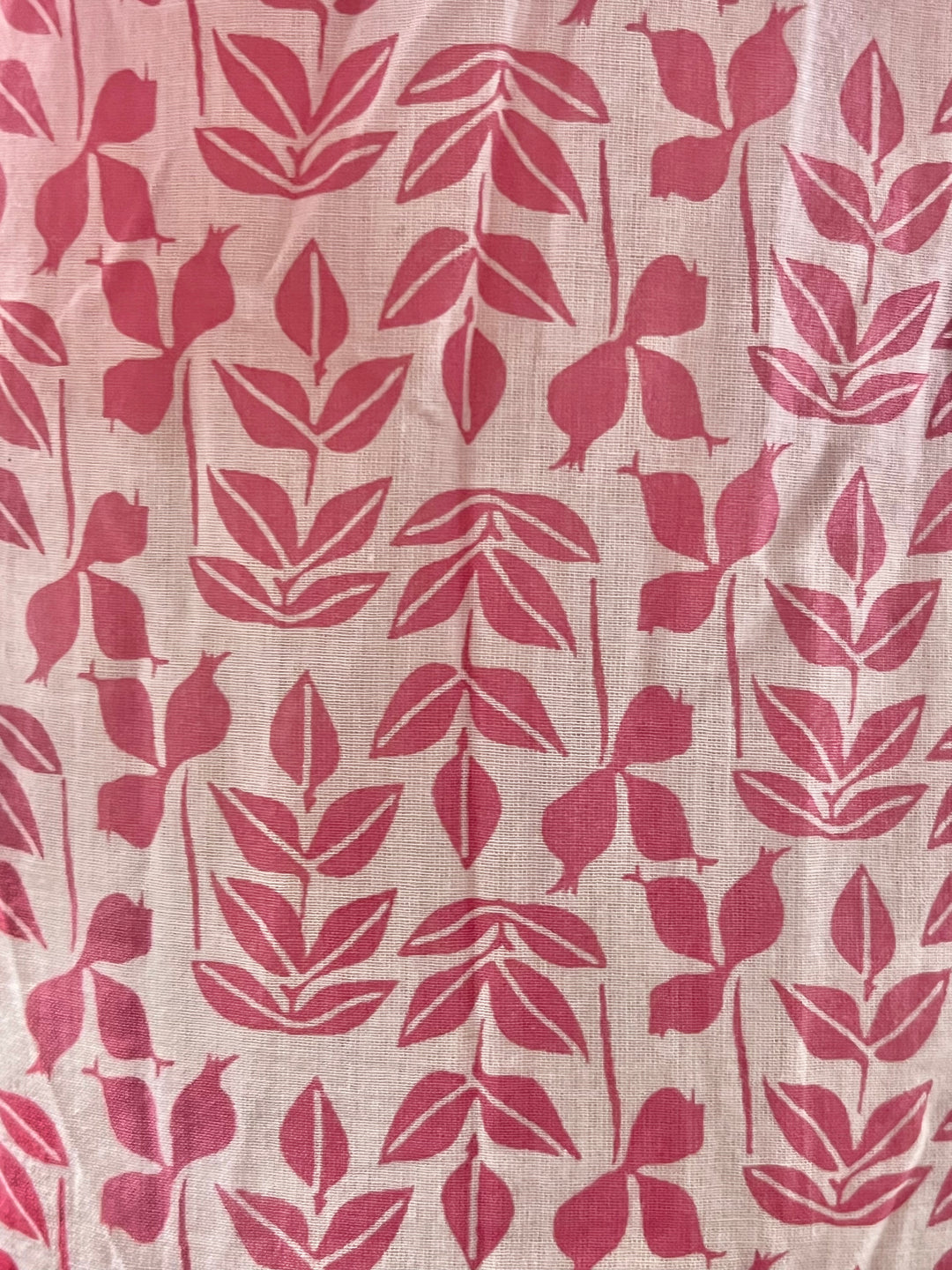 Fabric with red leaf pattern on a beige background