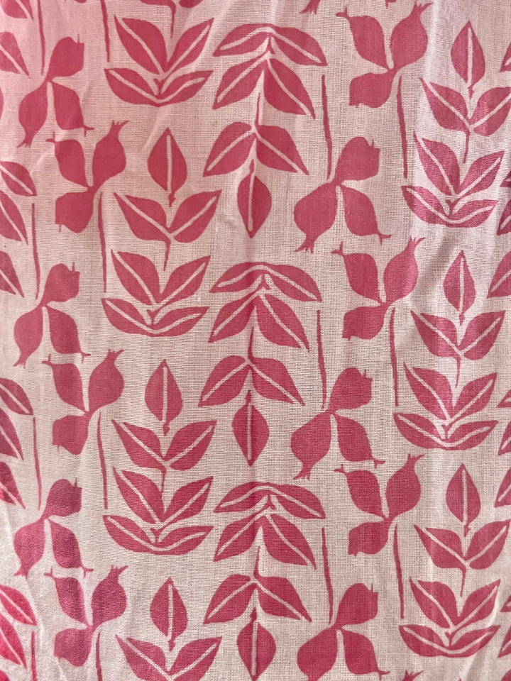 Fabric with red leaf pattern on a beige background