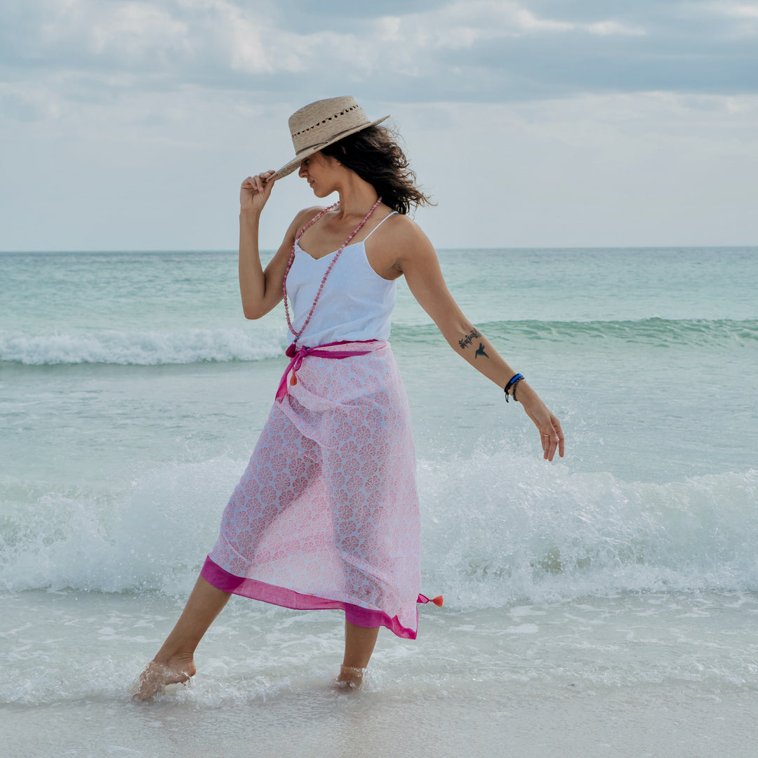 woman in pink beach cover up with printed pattern