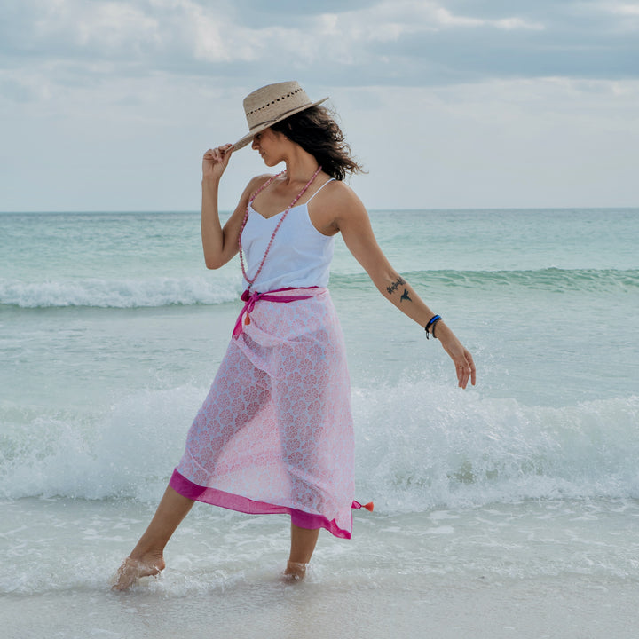 woman in pink beach cover up with printed pattern